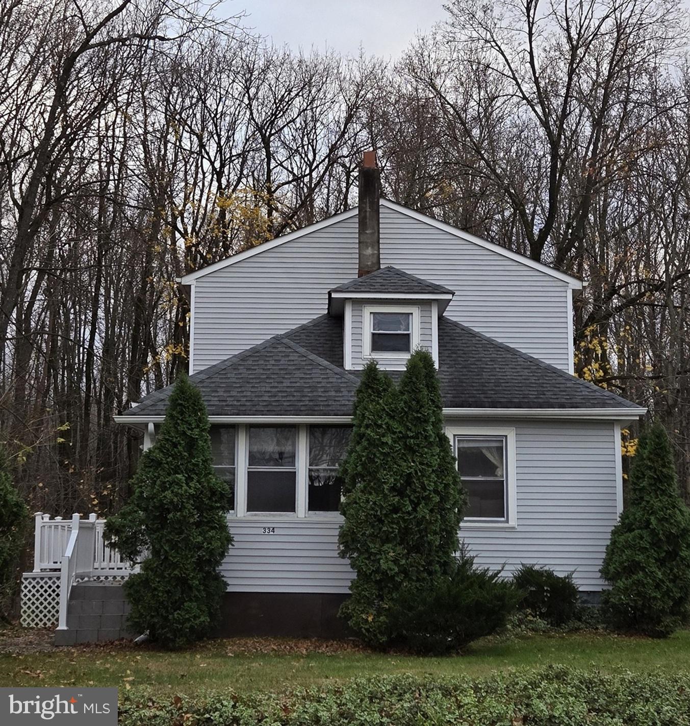 a front view of house with a garden