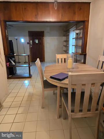 a dining room with furniture and a chandelier