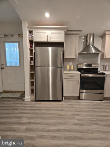 a kitchen with stainless steel appliances a refrigerator stove and microwave