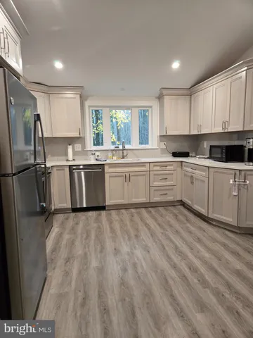 a kitchen with a sink stove and refrigerator