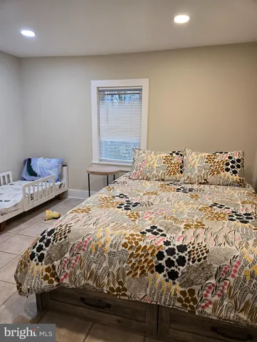 a bed sitting in a bedroom next to a window