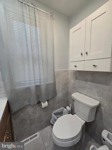 a white toilet sitting next to a sink