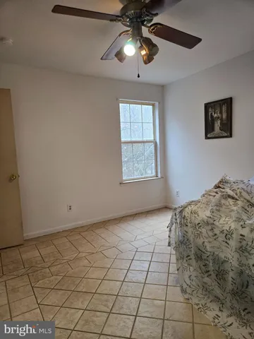 a view of a livingroom with a ceiling fan and window