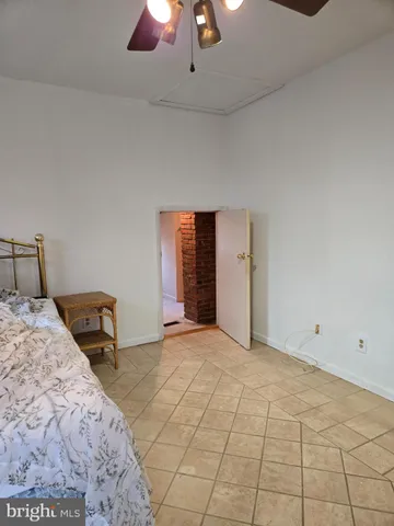 a bedroom with a bed and a lamp