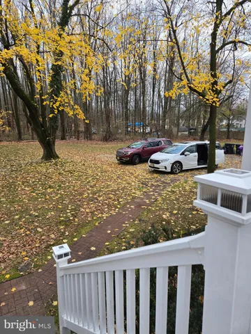 a view of a yard with wooden fence