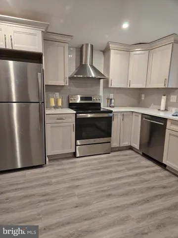 a kitchen with a refrigerator sink and cabinets