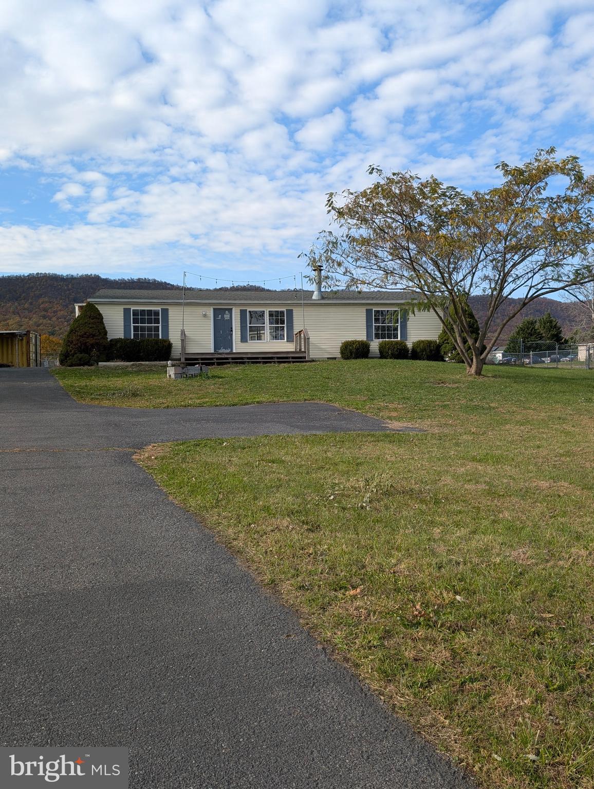 11365 Punch Bowl Road, Unit 3 Mercersburg, PA 17236 - Photo 1 of 1 a view of a big house with a big yard and large trees