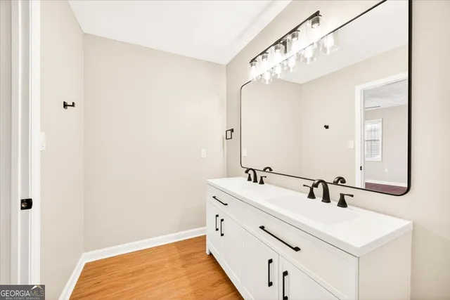 a view of an empty room with a fireplace and a window