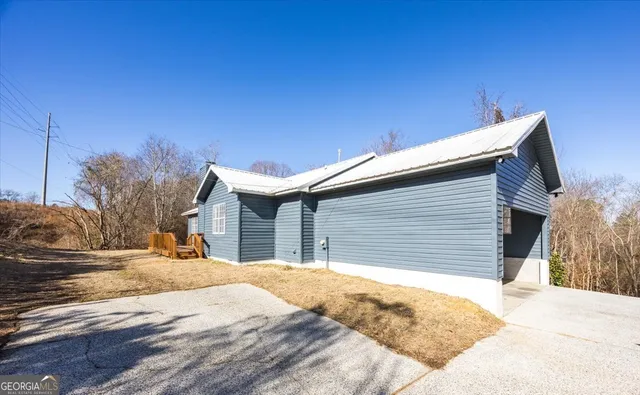 a view of a house with a wooden fence