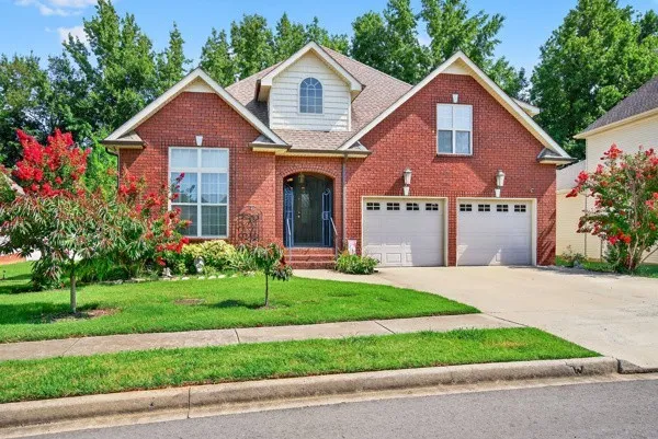 a front view of a house with a yard and garage