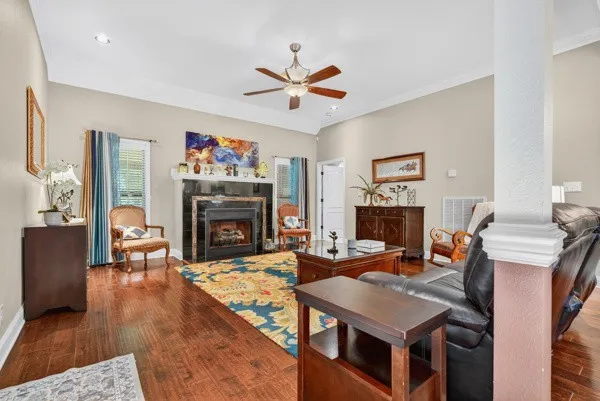 a living room with furniture a fireplace and a flat screen tv