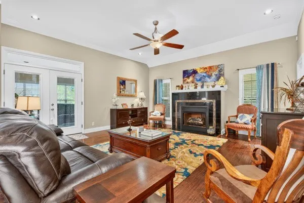 a living room with furniture a fireplace and a large window