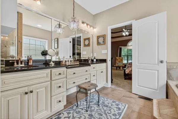 a spacious bathroom with a double vanity sink a mirror and a bathtub