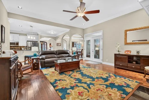 a living room with furniture and a wooden floor