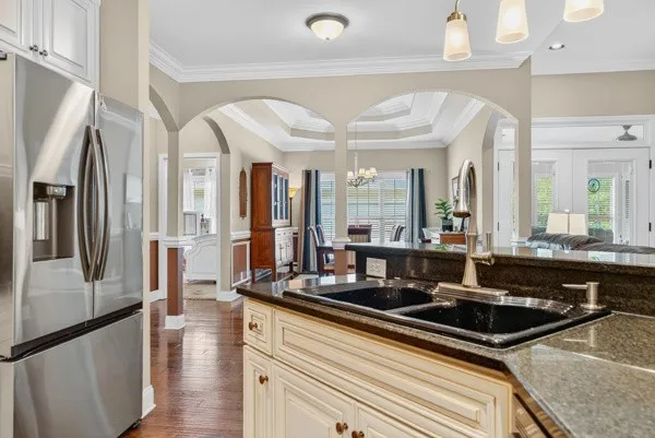 a kitchen with stainless steel appliances granite countertop a sink stove and refrigerator