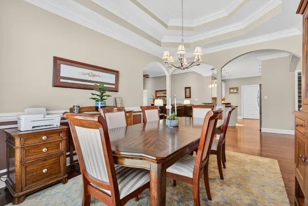 a view of a dining room with furniture and chandelier