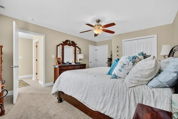 a bed room with a bed and a ceiling fan