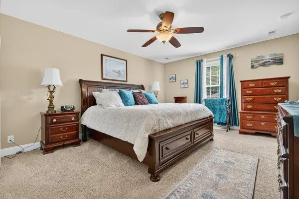 a spacious bedroom with a bed a chandelier and closet