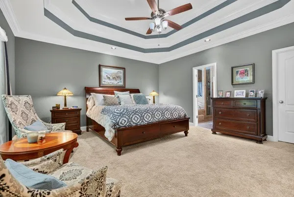 a bedroom with a bed and a chandelier