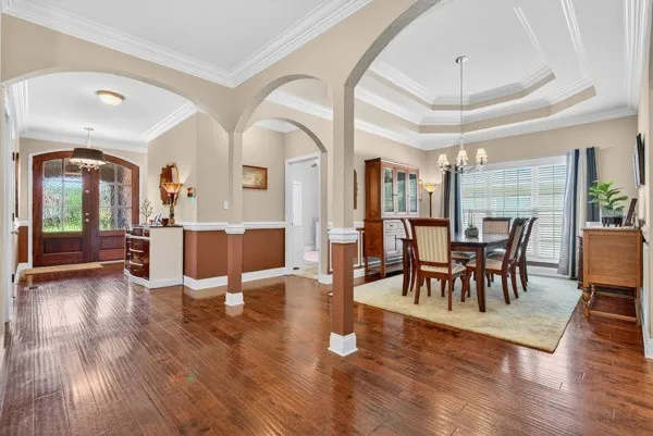 a view of a dining room with furniture and wooden floor