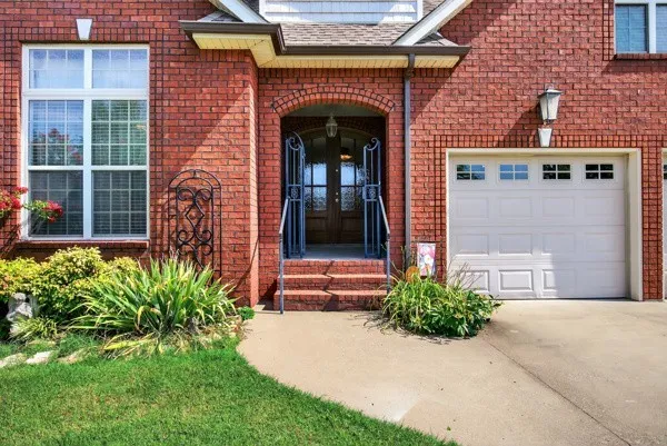 a front view of a house with a yard and garage