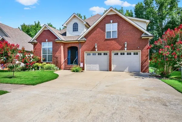 a front view of a house with a yard and garage