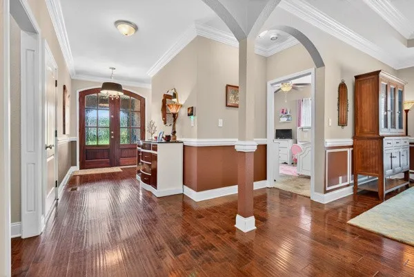 a room with wooden floors and glass windows