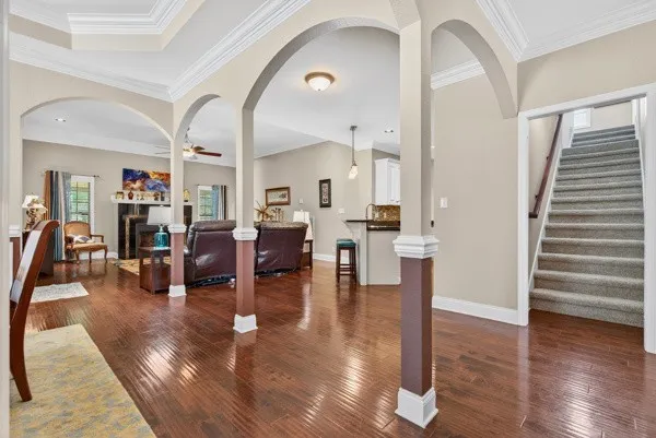 a living room with fireplace furniture and wooden floor
