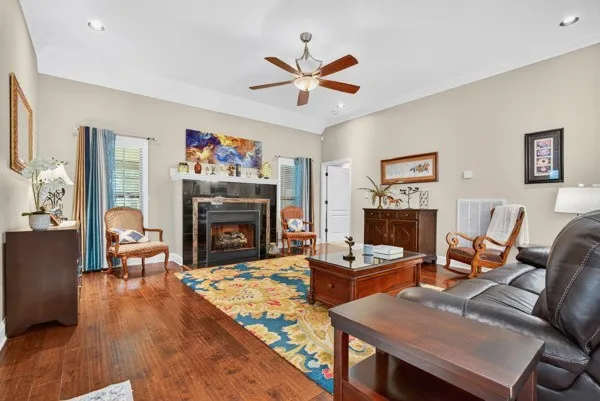 a living room with furniture a fireplace and a window