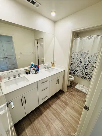 a bathroom with a double vanity sink and mirror