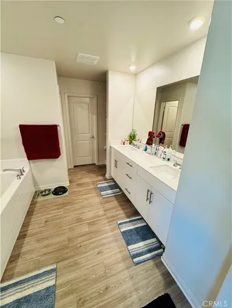 a bathroom with a sink mirror and window