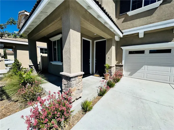 a front view of a house with a flower garden