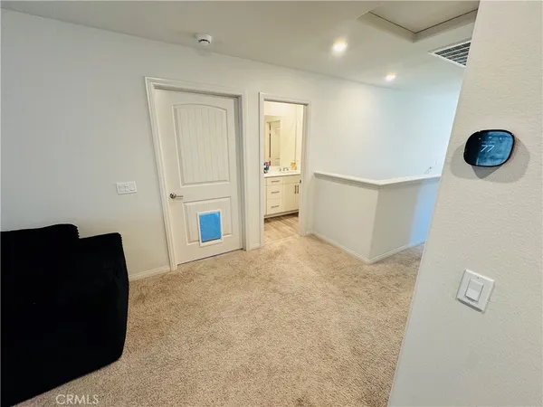a view of an empty room with a kitchen