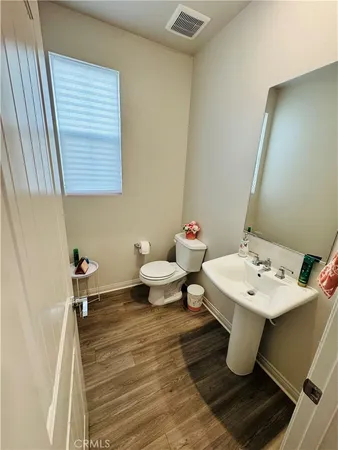 a bathroom with a sink mirror and toilet