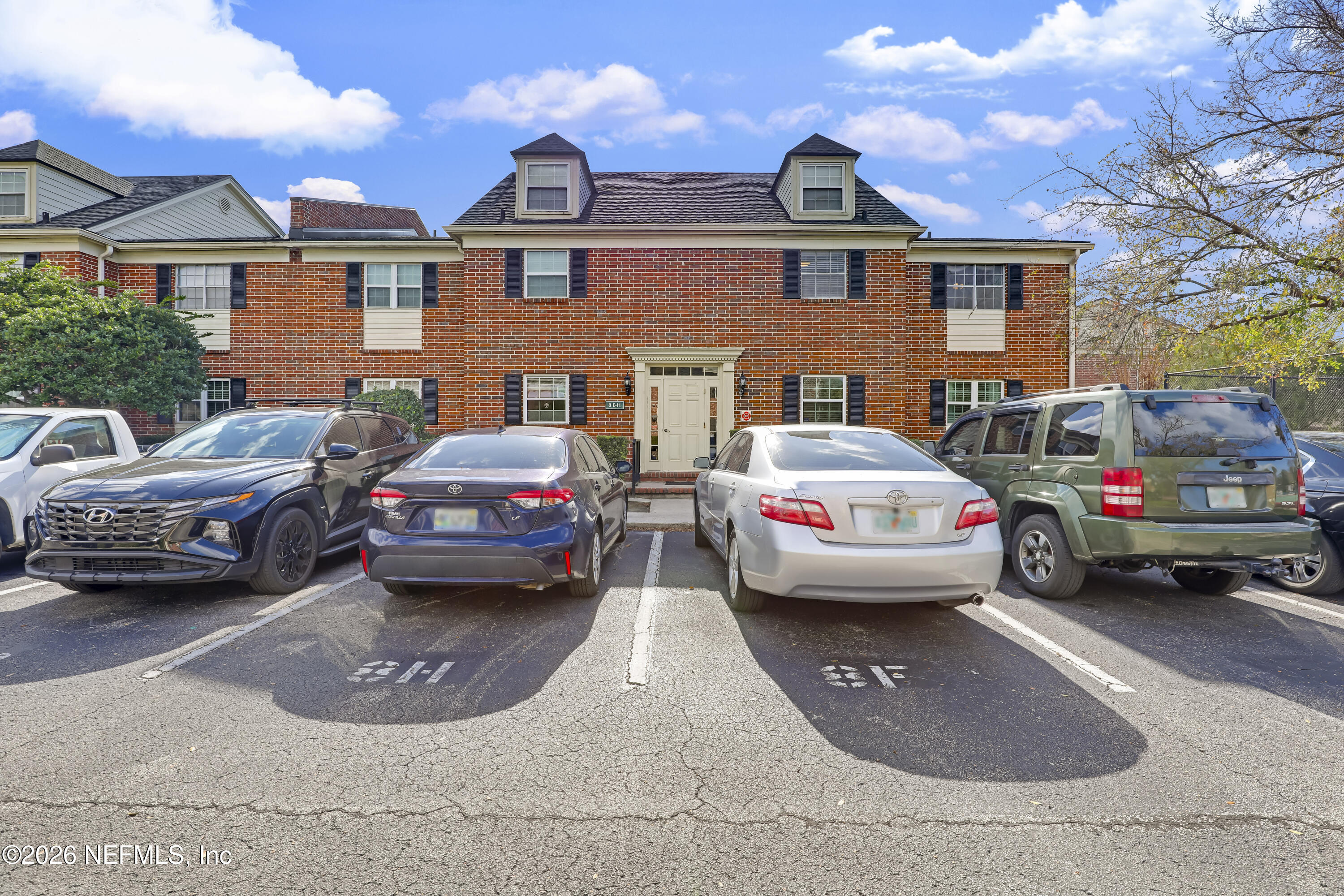 a view of a cars park in front of a house