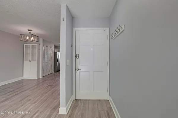 a view of a hallway with wooden floor