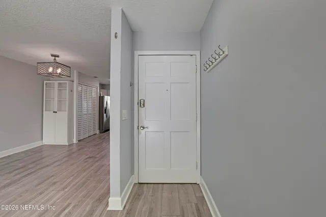 a view of a hallway with wooden floor