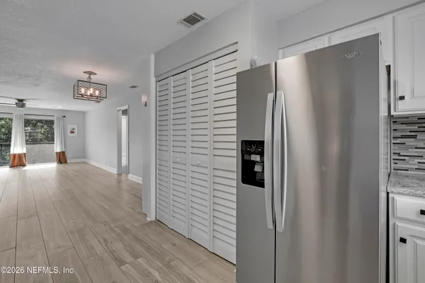 a view of hallway with wooden floor
