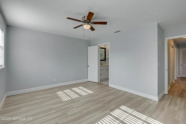 a view of empty room with wooden floor