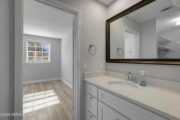 a bathroom with a sink a vanity and a mirror