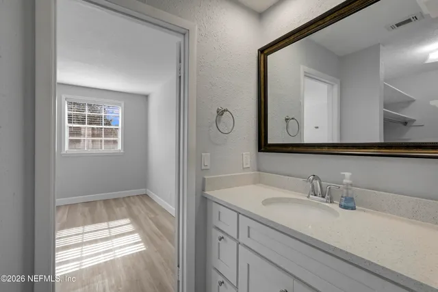 a bathroom with a sink a vanity and a mirror