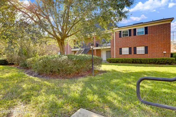 a view of house with a yard