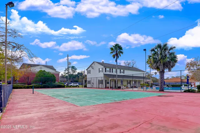 a view of a building with a yard in front of it