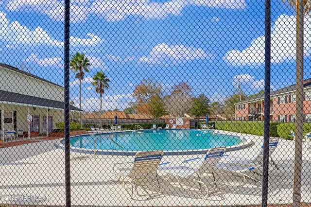 a view of a patio with a table and chairs