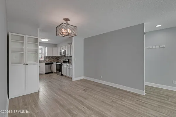 a view of a kitchen with wooden floor and a kitchen