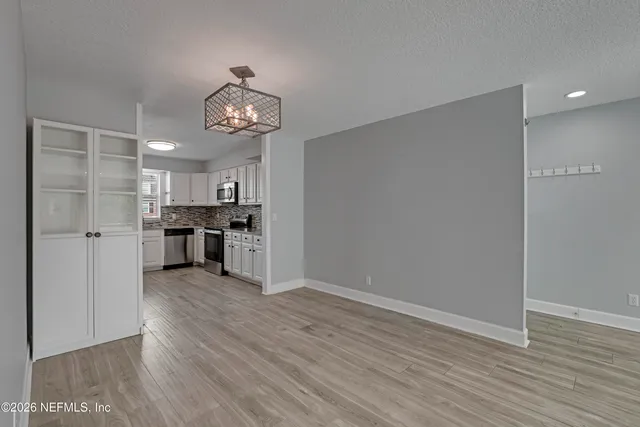 a view of a kitchen with wooden floor and a kitchen