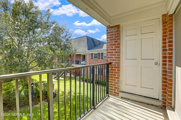 a view of a balcony with wooden floor