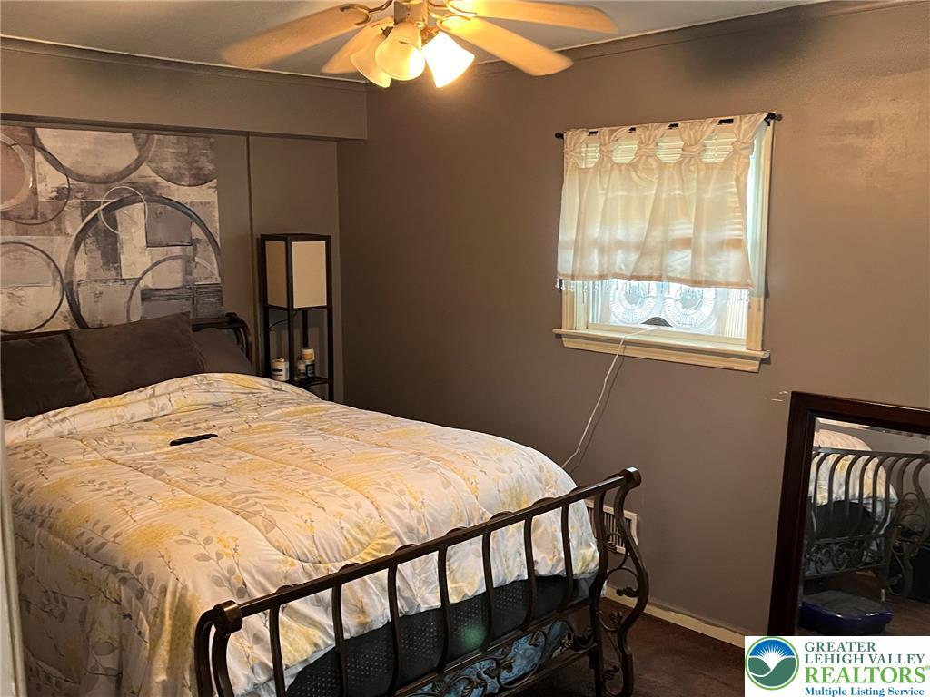 765 3rd Street Whitehall, PA 18052 - Photo 21 of 30 A comforting bedroom features a ceiling fan, a window, and durable flooring.