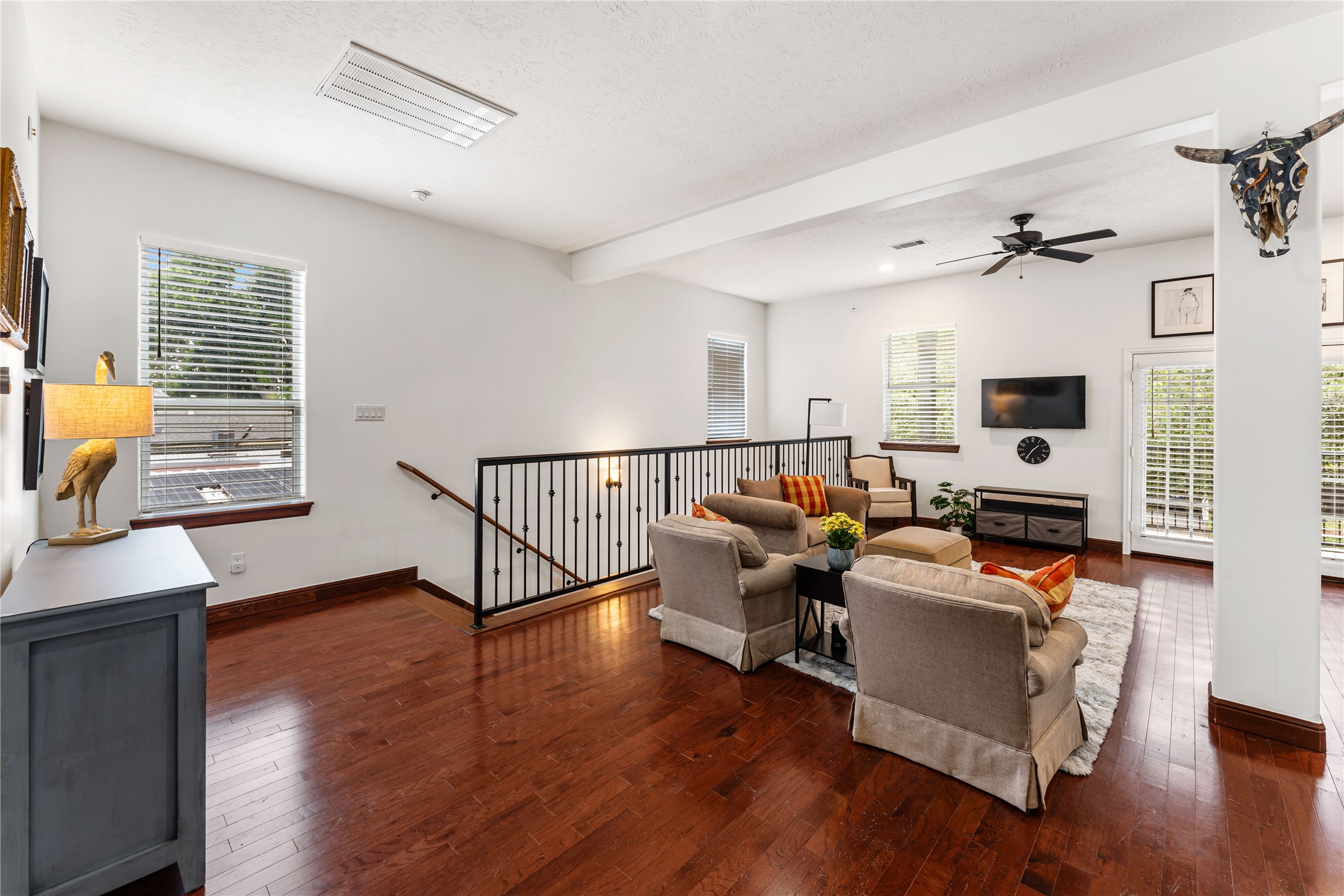415 West 8th Street Houston, TX 77007 - Photo 20 of 39 Relax in the generously sized living room featuring hardwood flooring, recessed lighting, oversized windows, and easy access to the covered balcony. The open layout offers endless flexibility for gathering with family and friends.