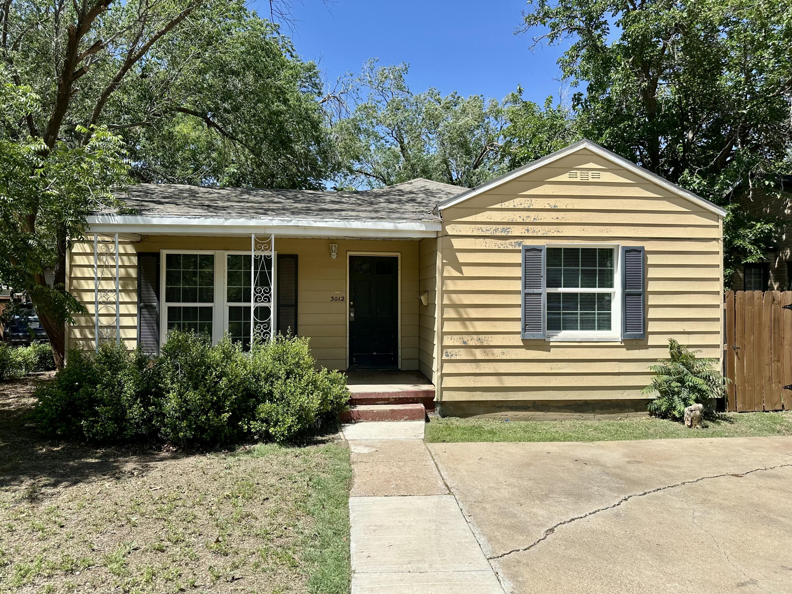 3012 22nd Street Lubbock, TX 79410 - Photo 1 of 11 a front view of a house with a yard and trees
